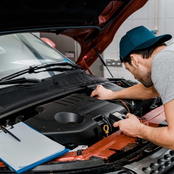 auto-mechanic-with-multimeter-voltmeter-checking-c-2023-11-27-05-21-08-utc-min-min
